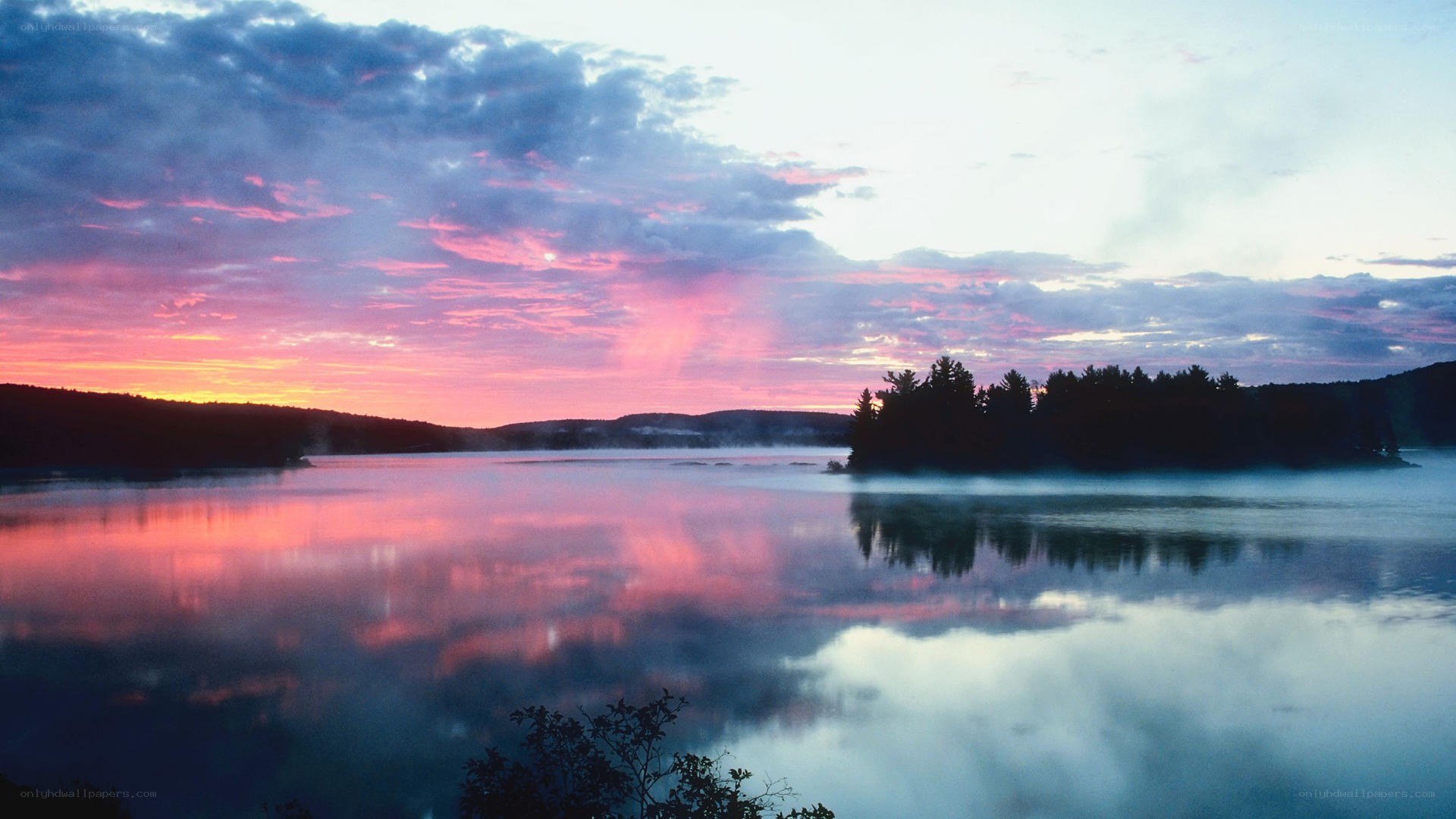 Sunset over misty lake