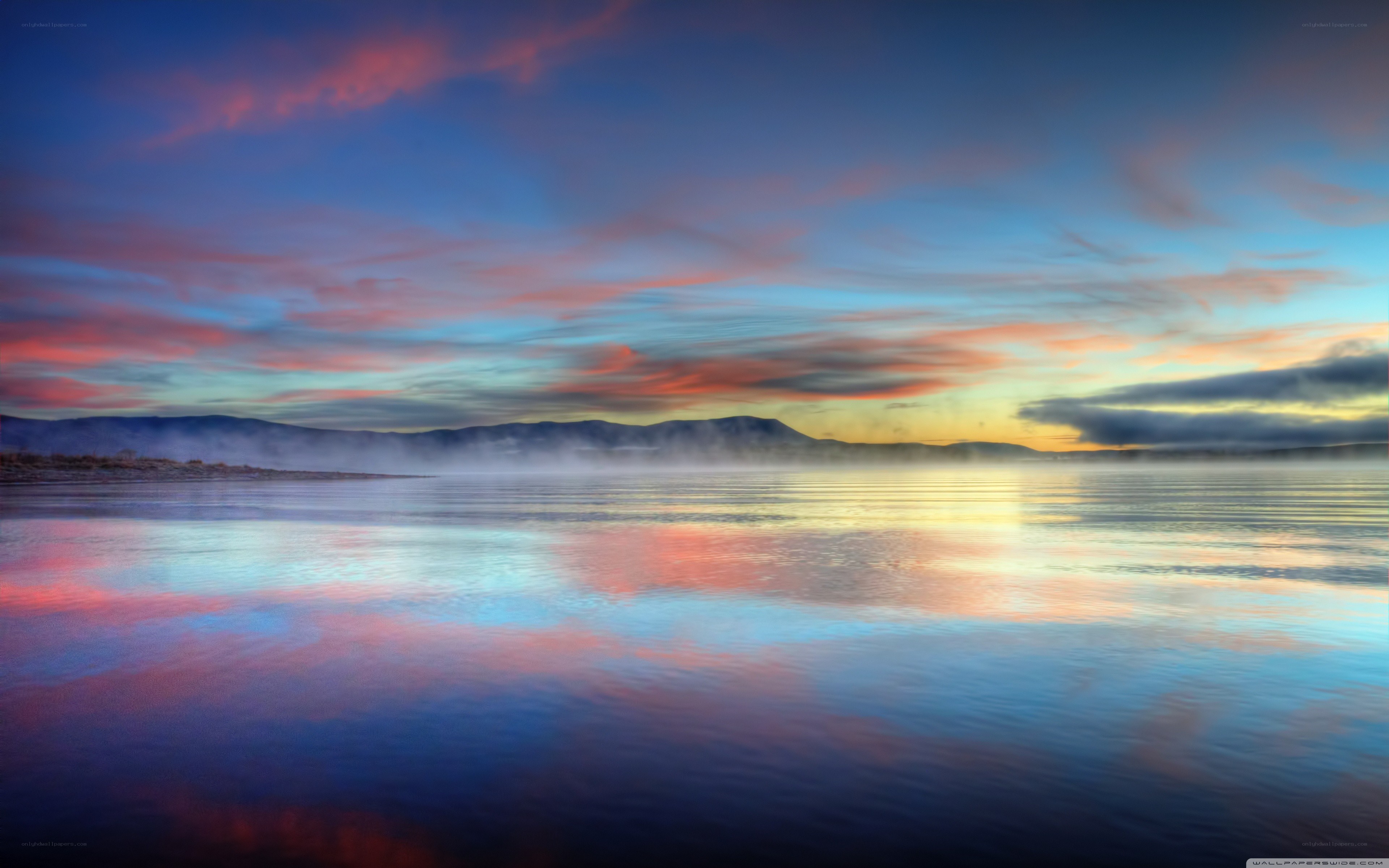Sunset over misty lake