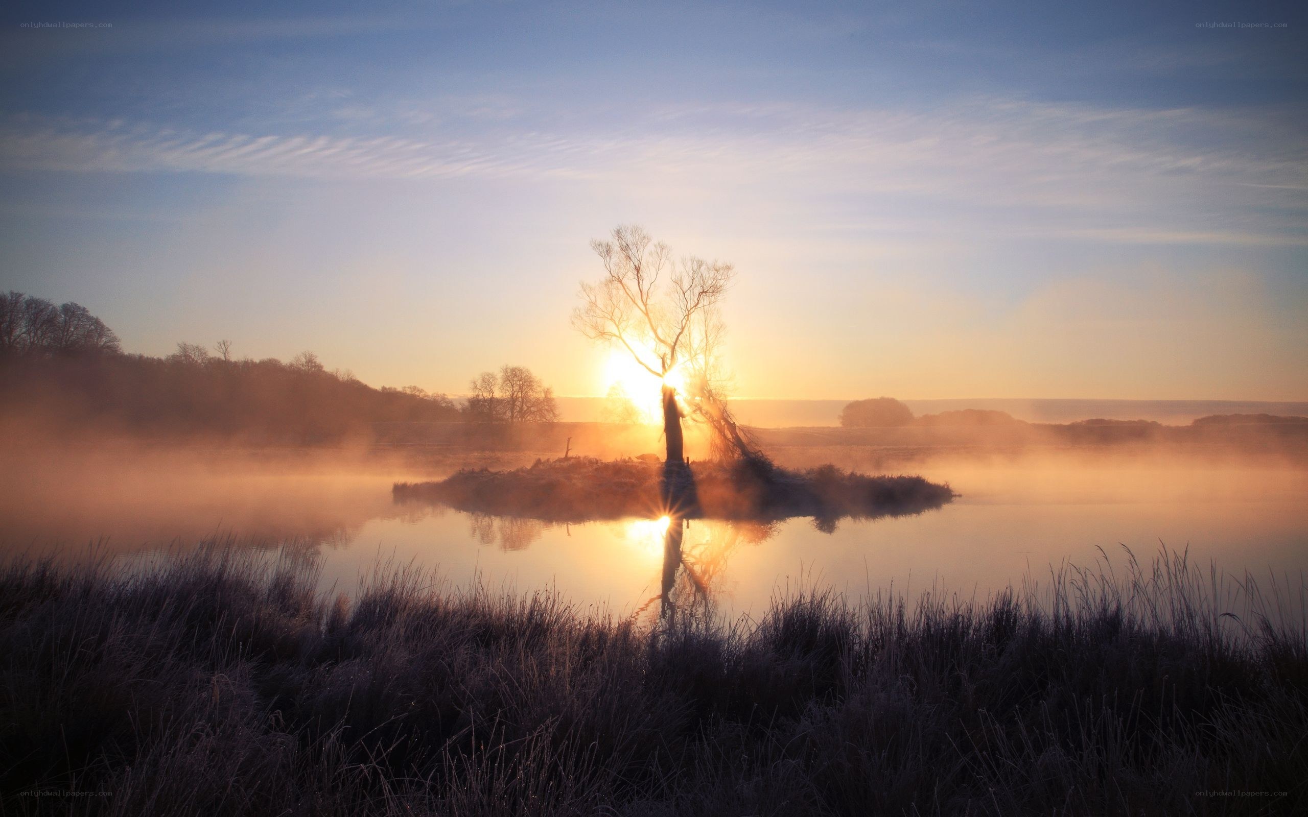 sunset over misty lake