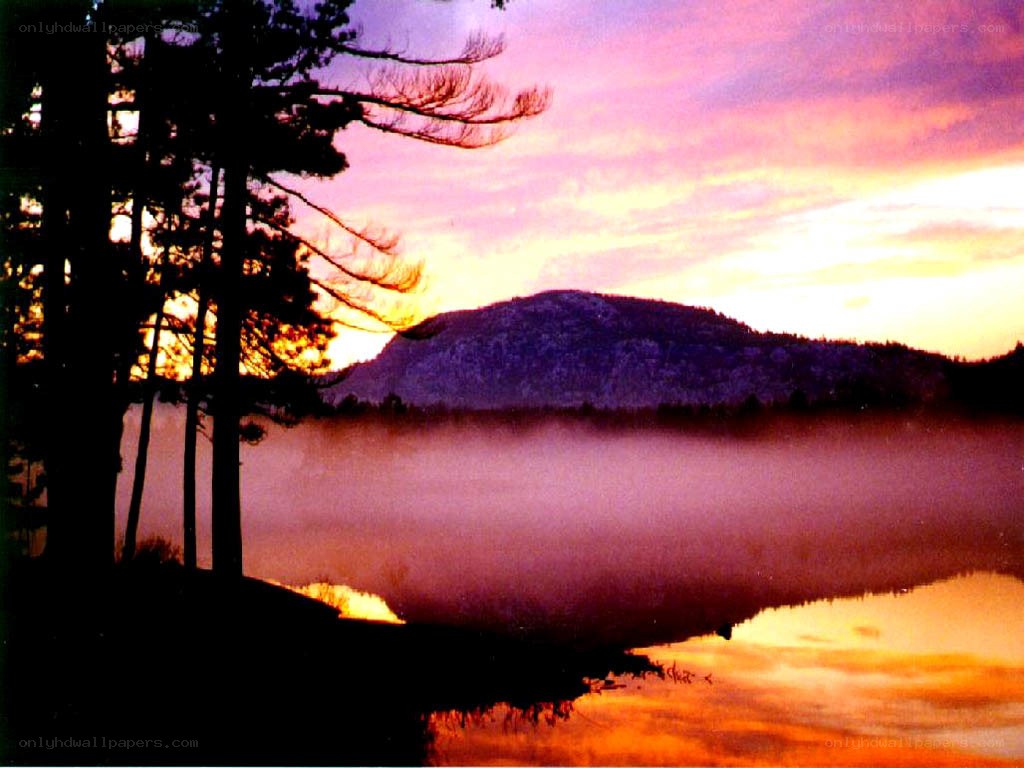 Sunset over misty lake