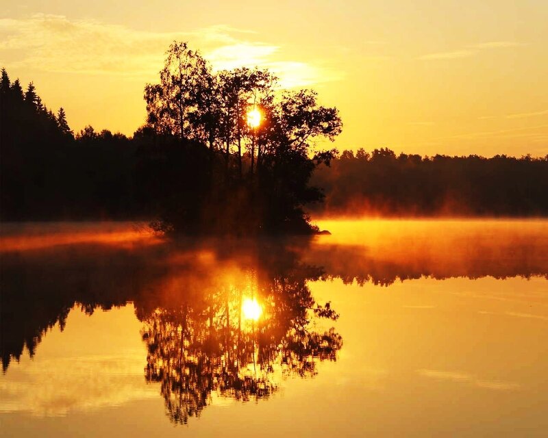 Sunset over misty lake