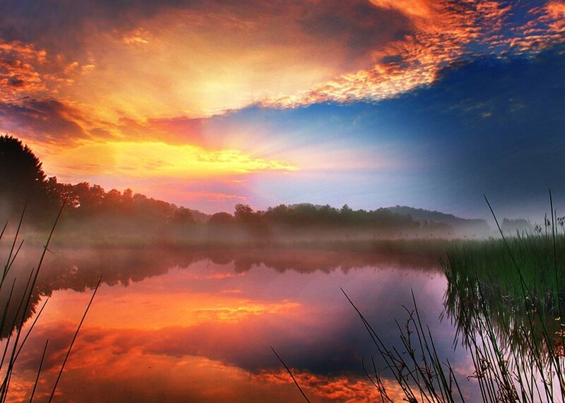 Sunset over misty lake