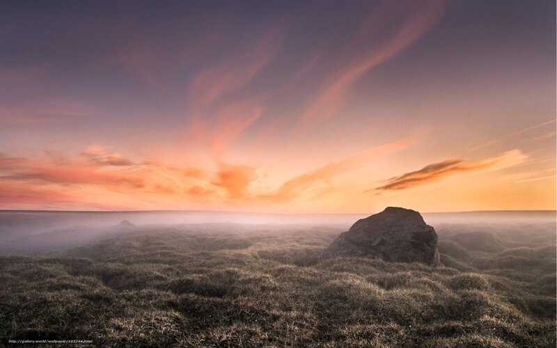 Sunset over misty moorland
