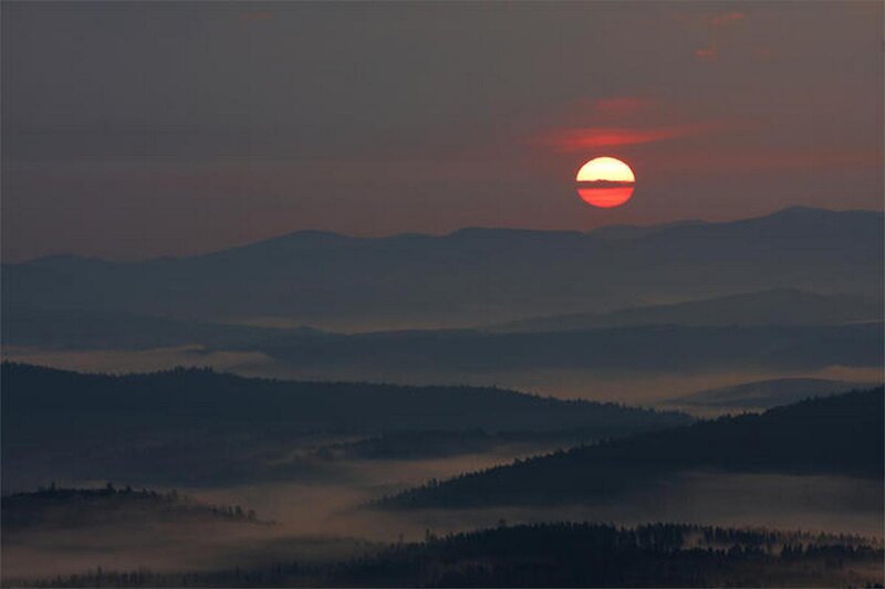 Sunset over misty mountains