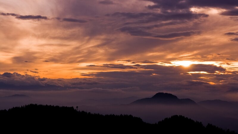 Sunset over misty mountains