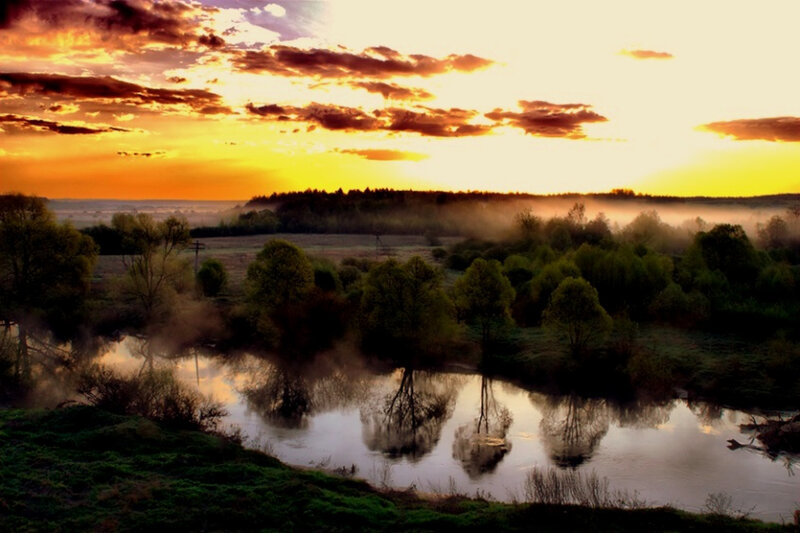 Sunset over misty river