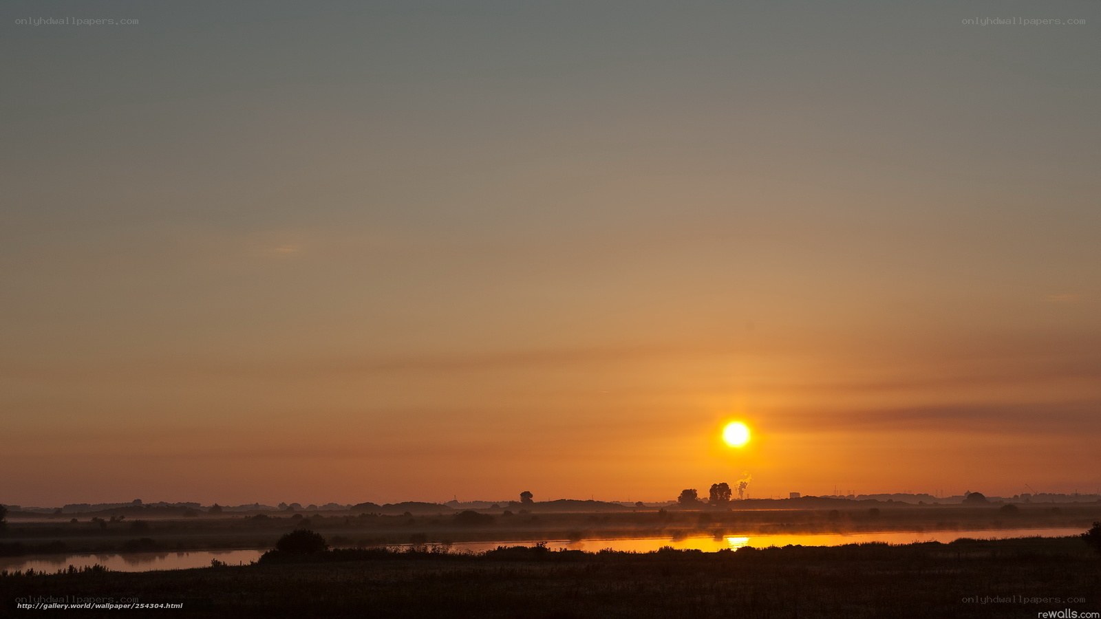 Sunset over misty wetlands
