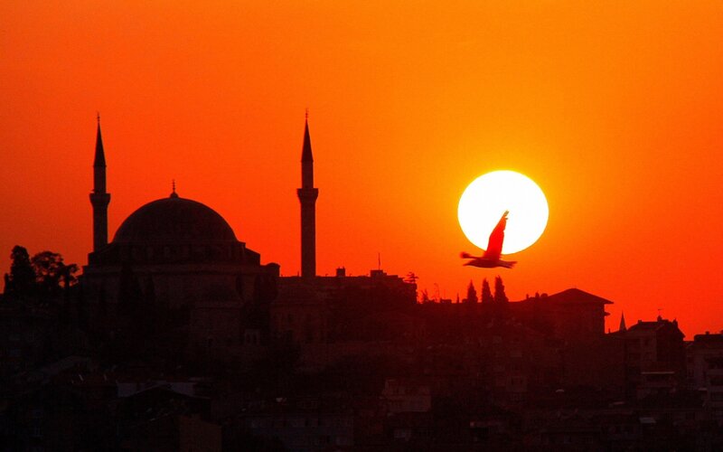 Sunset over mosque silhouette