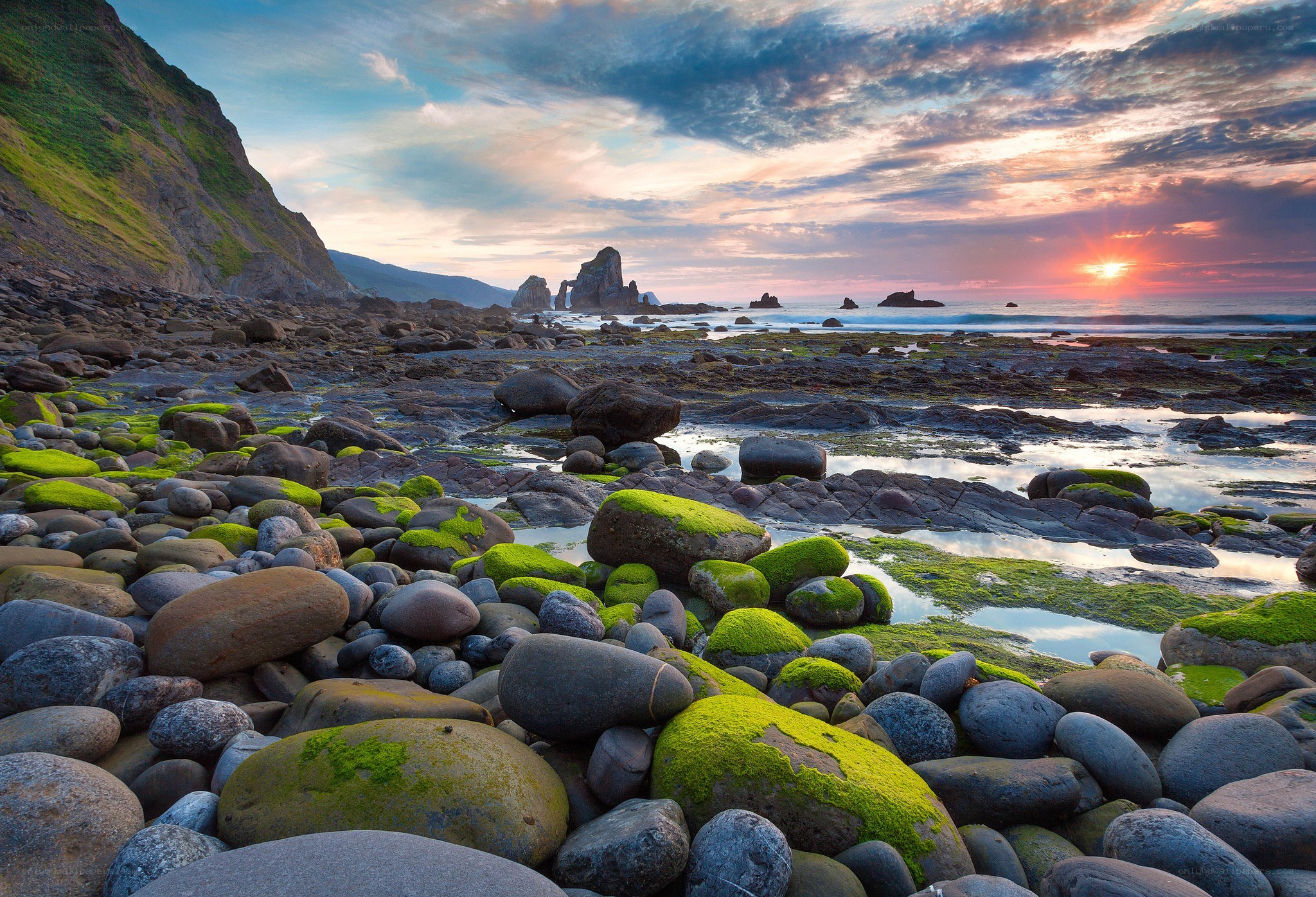 Sunset over mossy rocks
