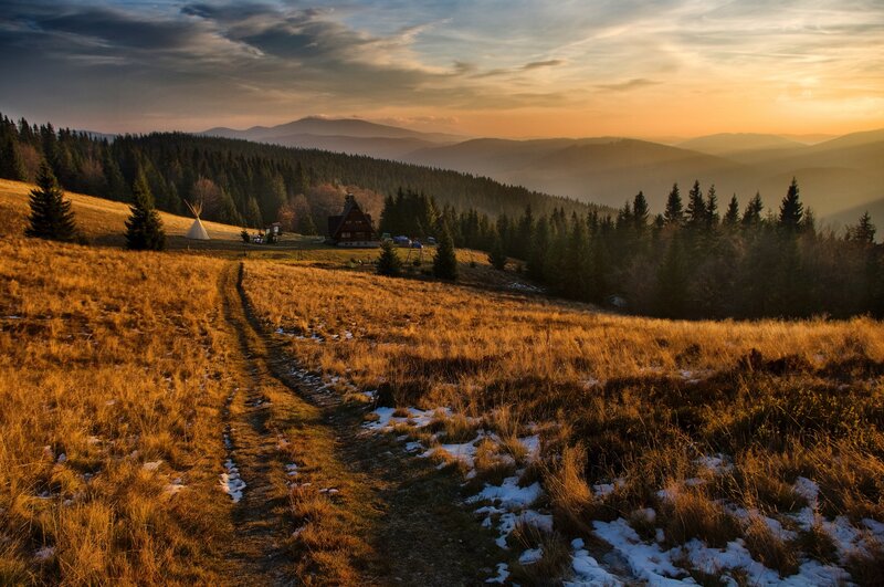 Sunset over mountain cabin