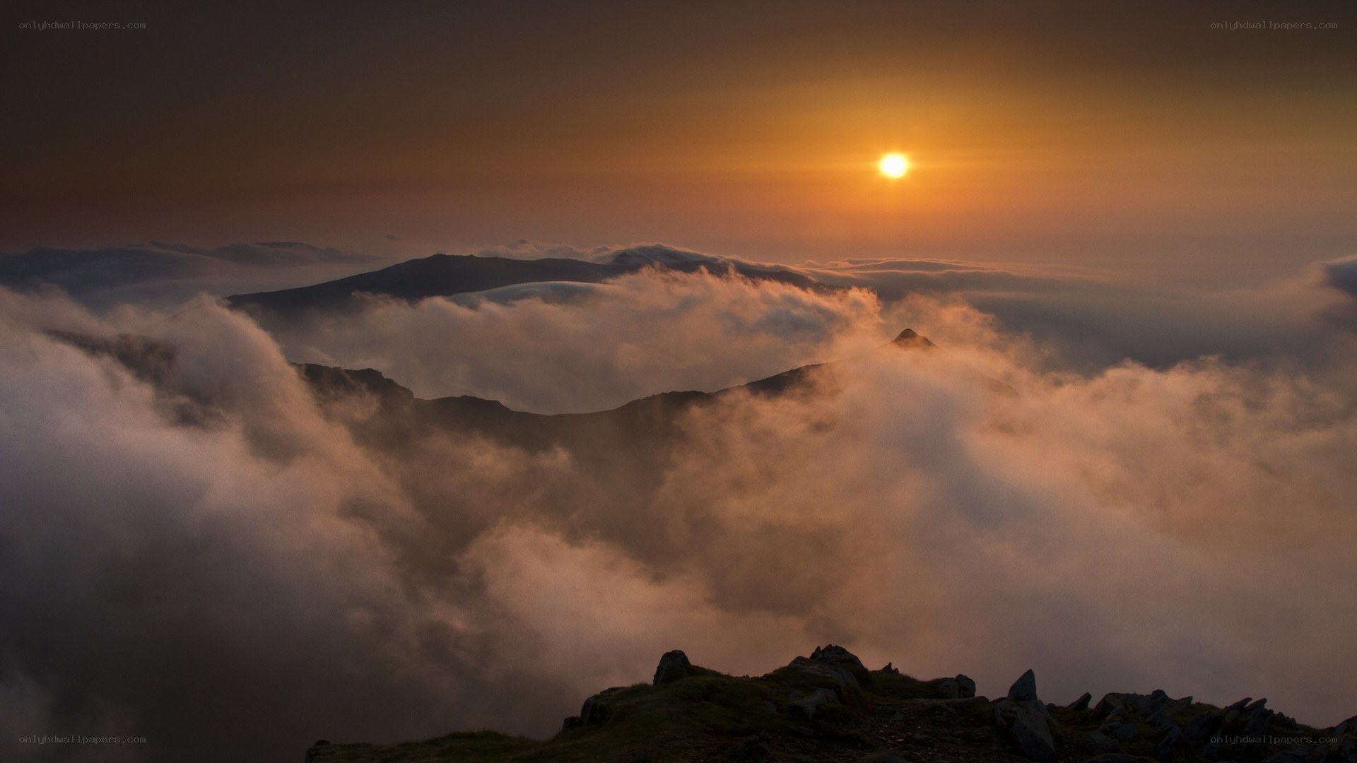 Sunset over mountain clouds
