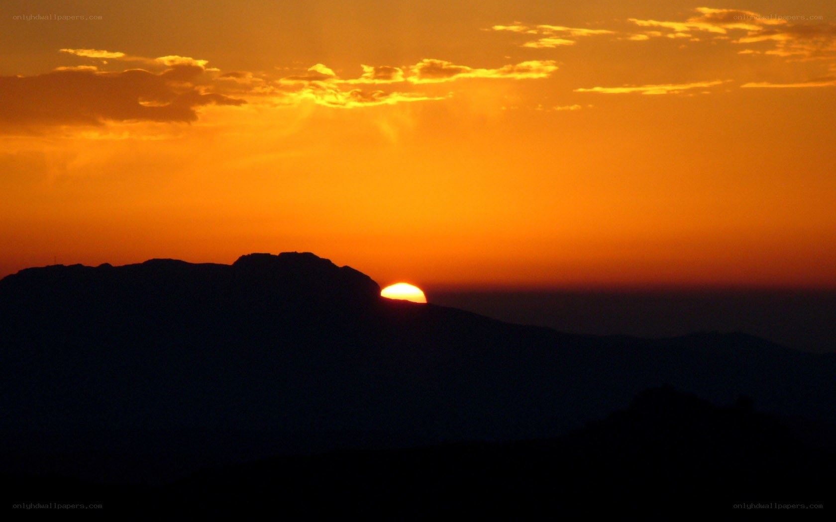 Sunset over mountain silhouette