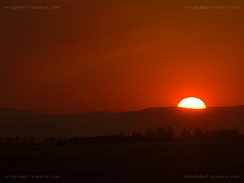 Sunset over mountain silhouette