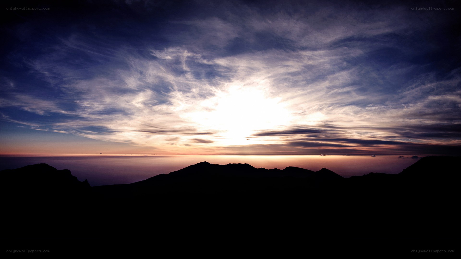 Sunset over mountain silhouette