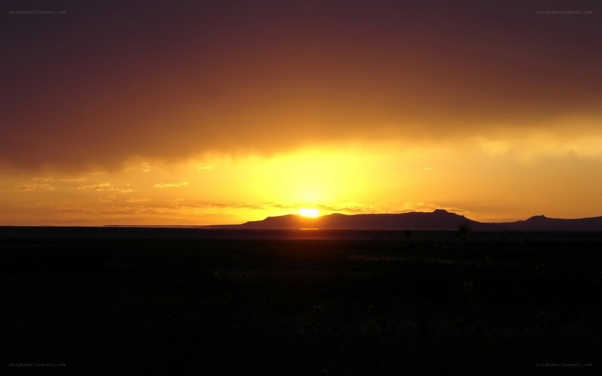 Sunset over mountain silhouette