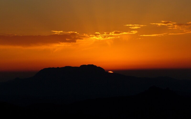 Sunset over mountain silhouette