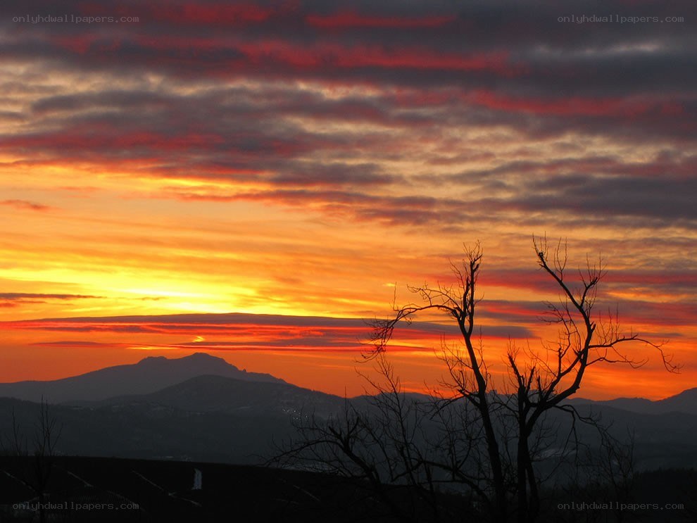 Sunset over mountain silhouette