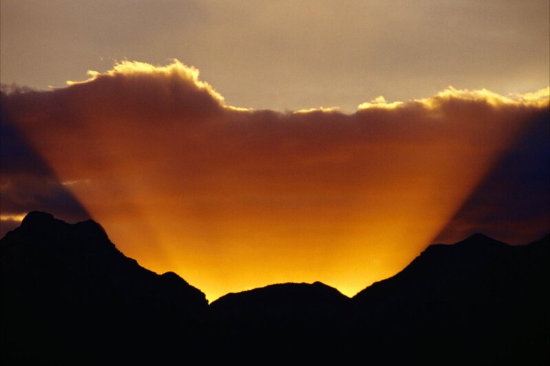 Sunset over mountain silhouette