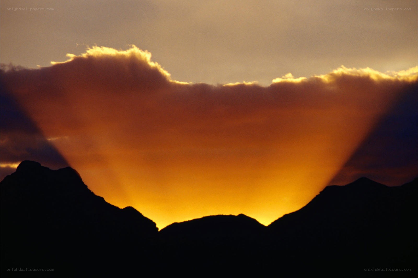 Sunset over mountain silhouette