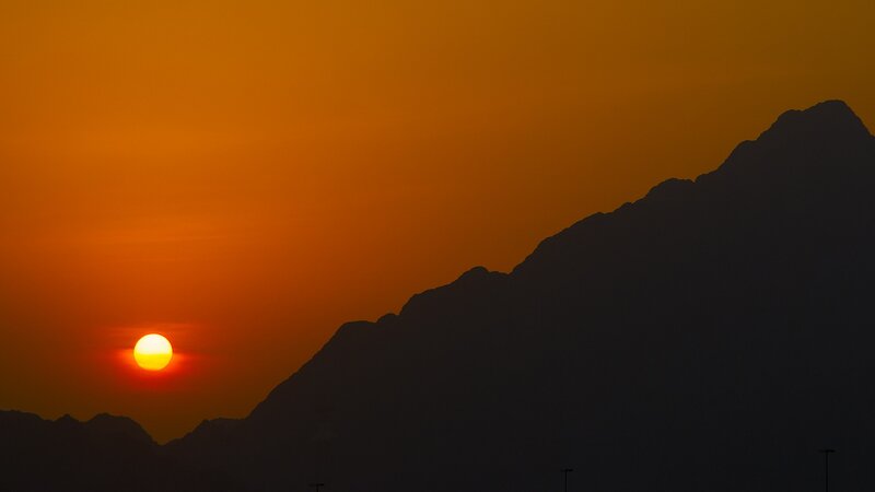 Sunset over mountain silhouette