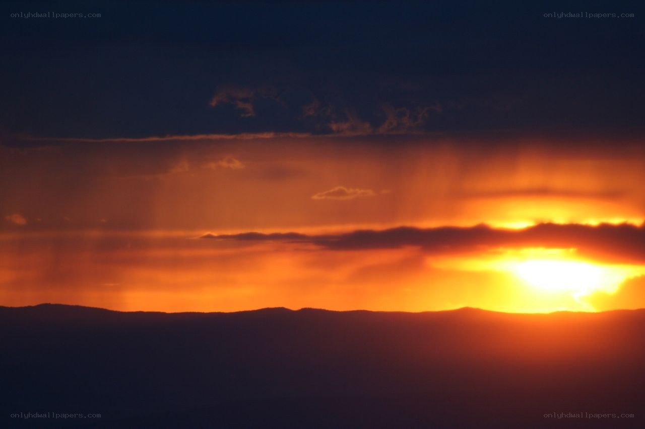 Sunset over mountain silhouette