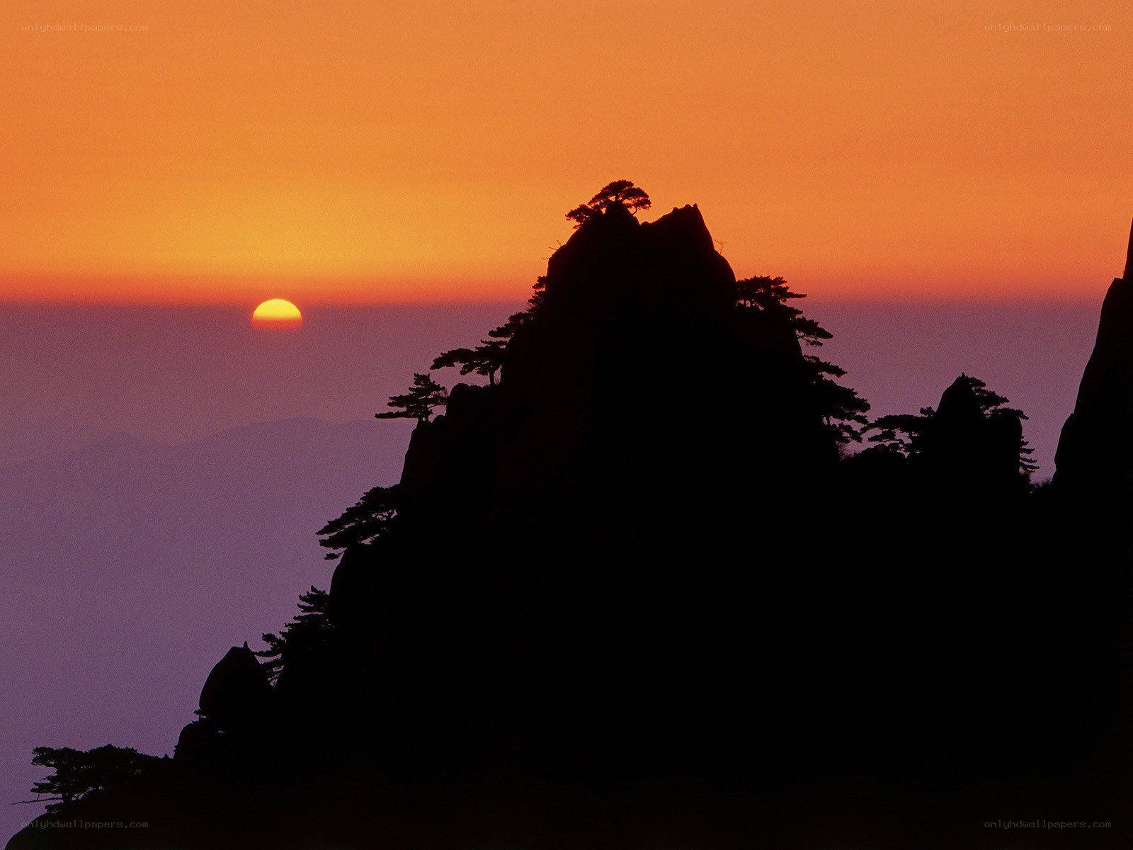 Sunset over mountain silhouette