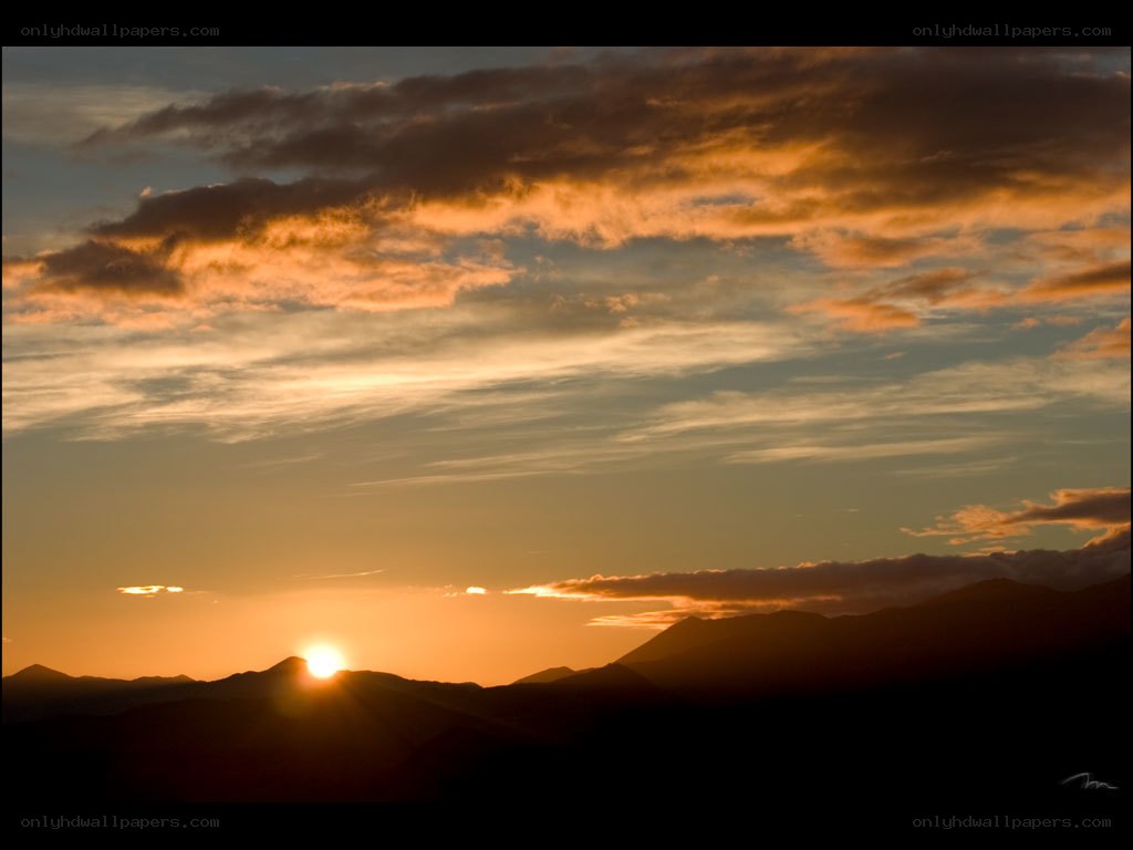 Sunset over mountain silhouettes