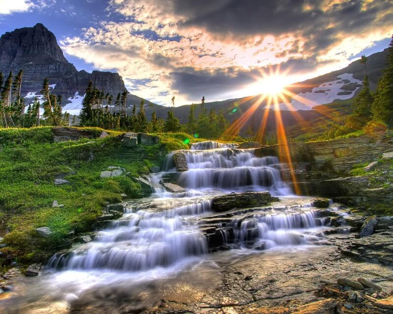 Sunset over mountain waterfall