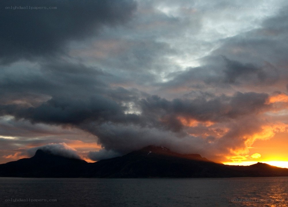 sunset over mountainous coast