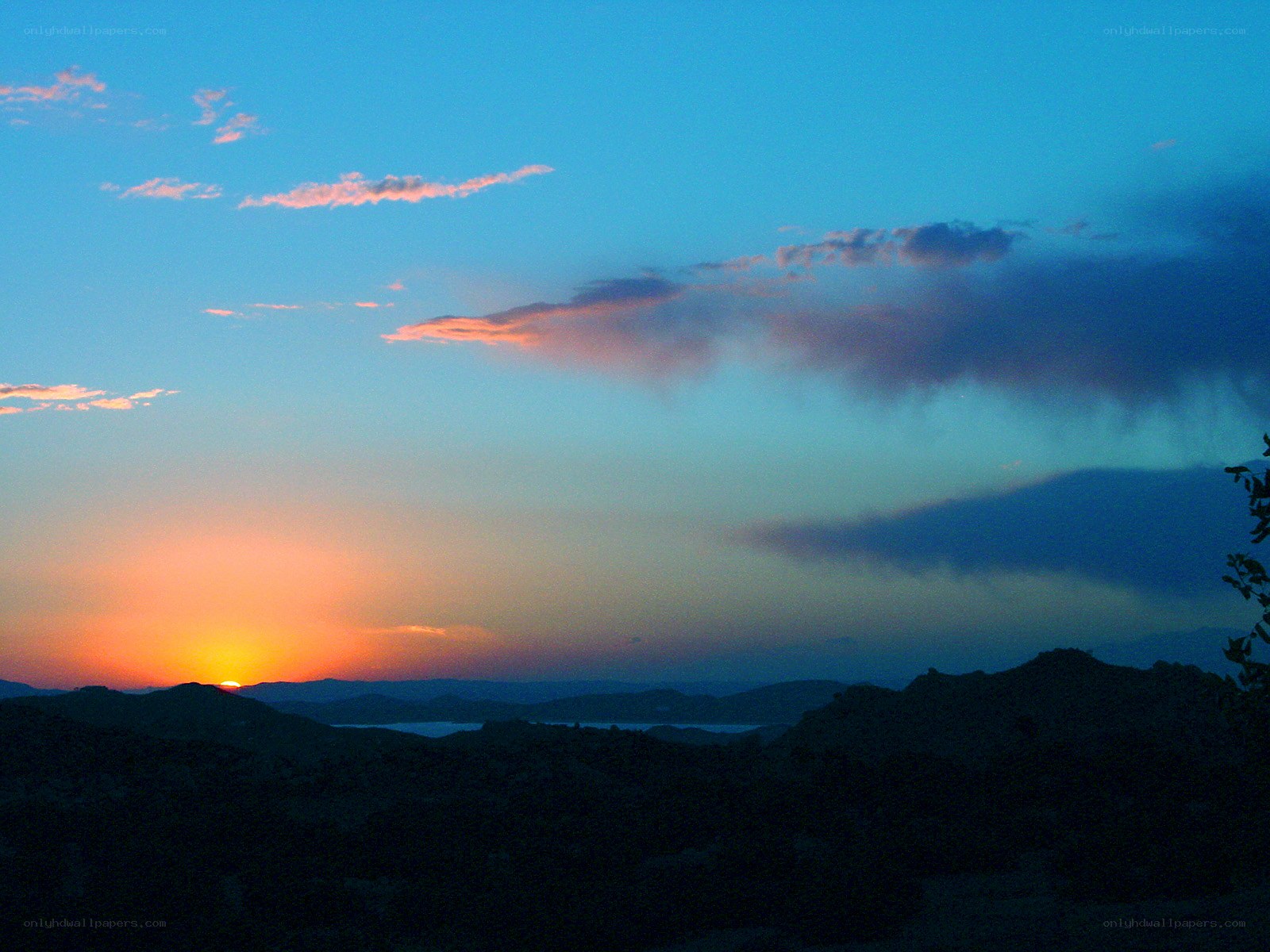 sunset over mountainous landscape