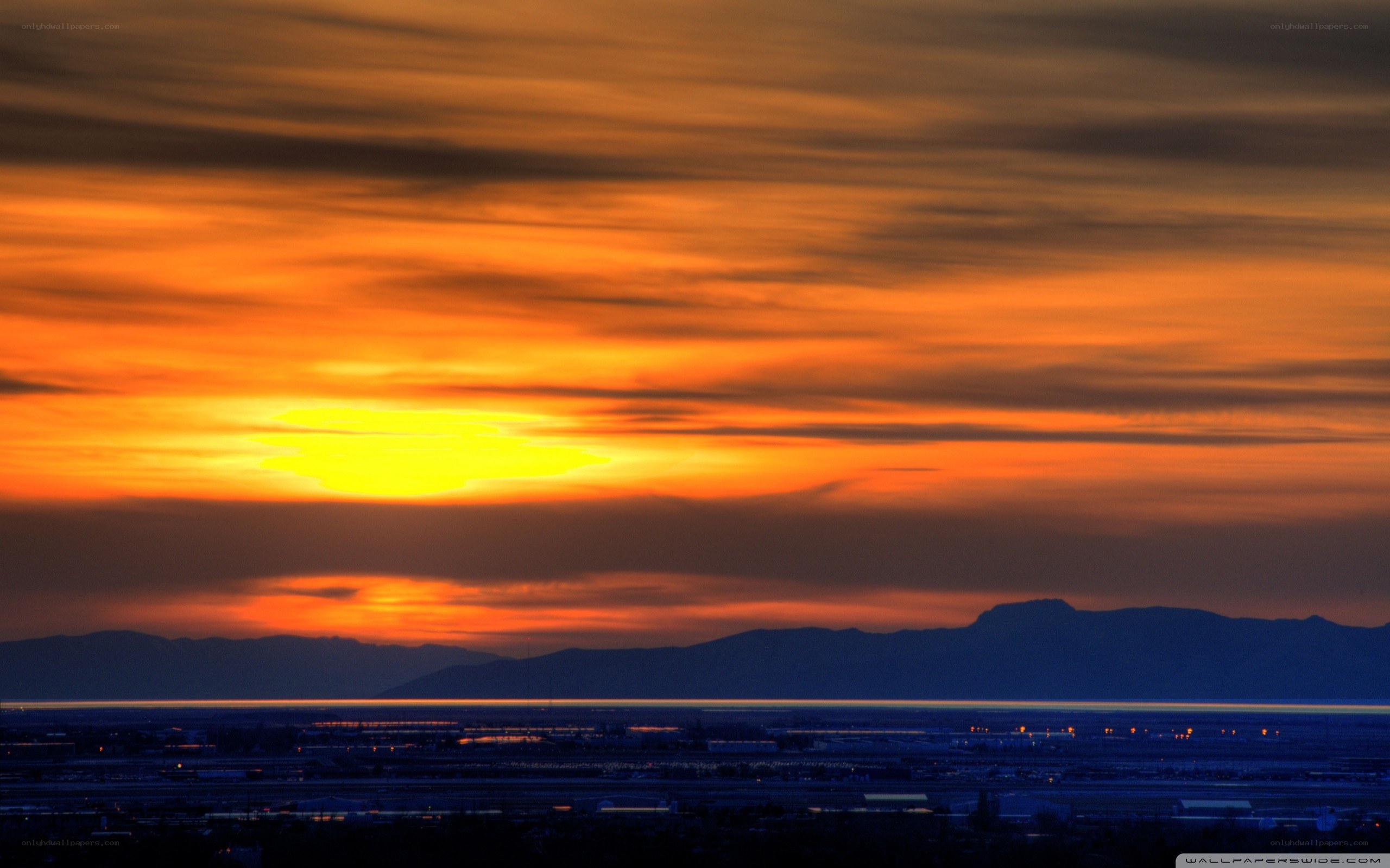 Sunset over mountains and city