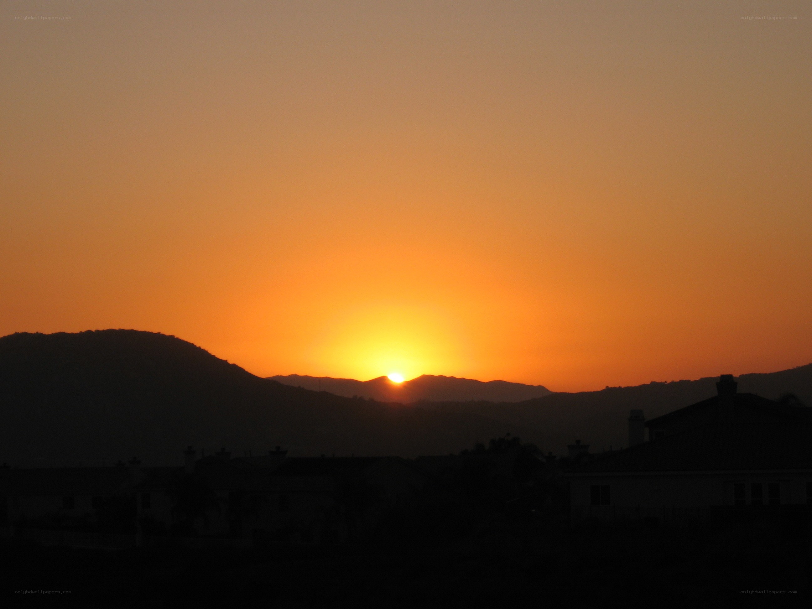 Sunset over mountains and houses