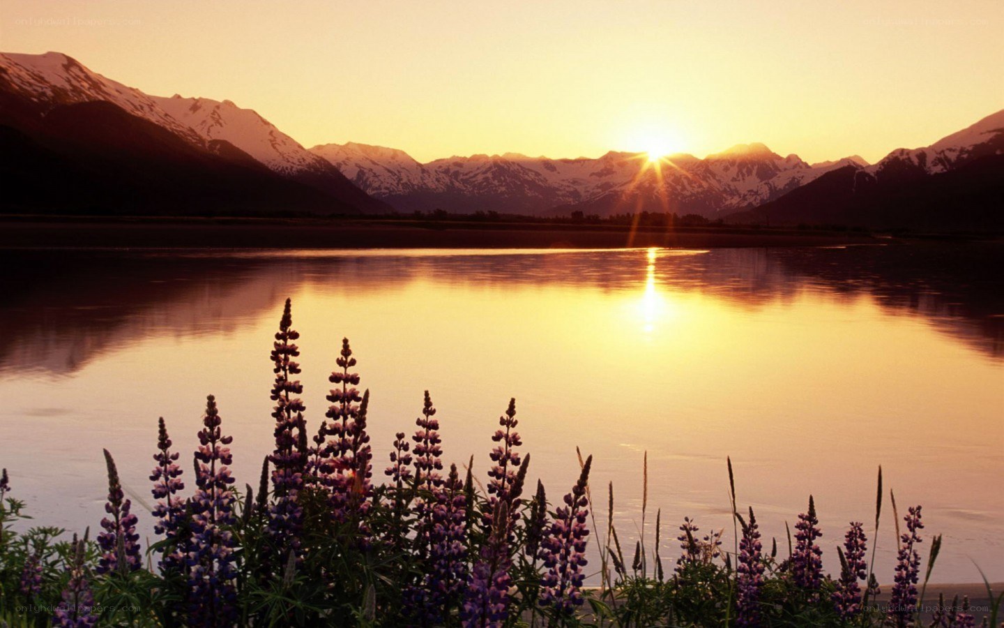 Sunset over mountains and lake