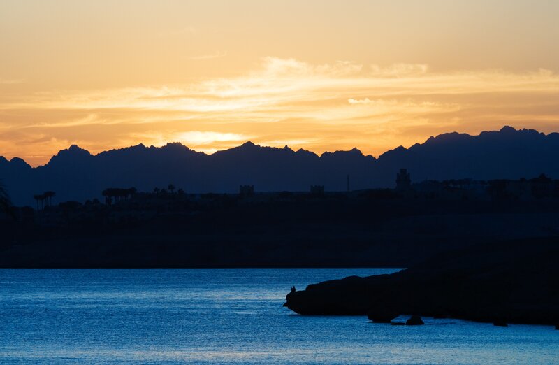 sunset over mountains and sea