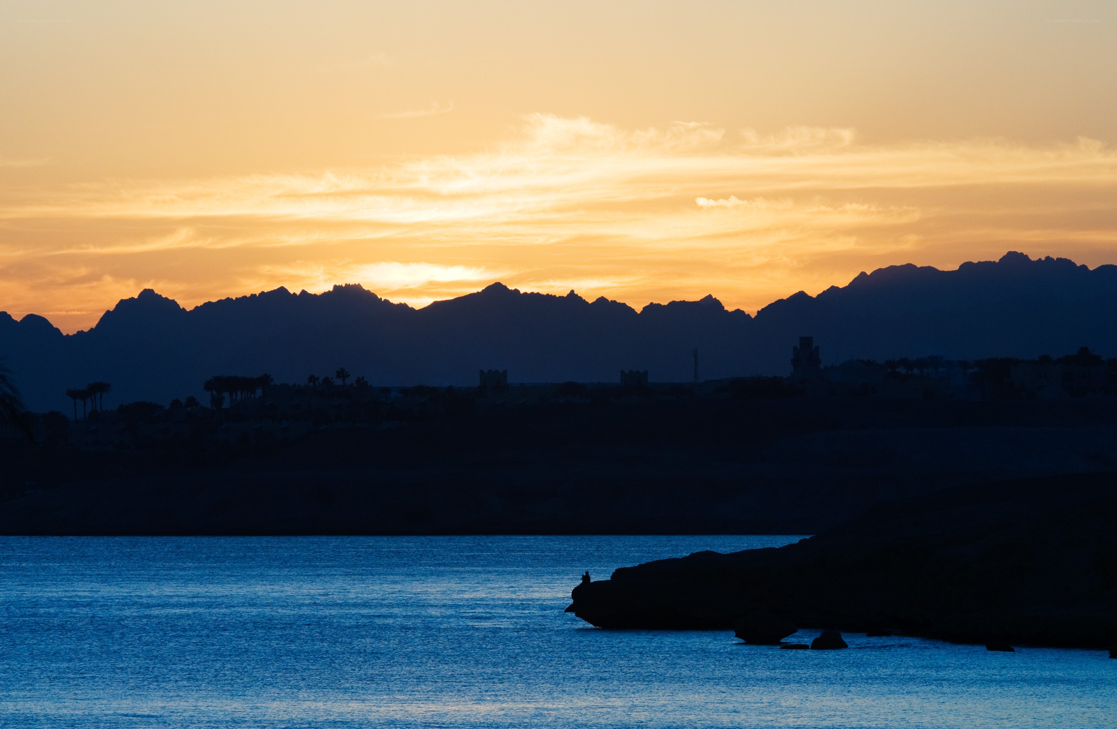 sunset over mountains and sea