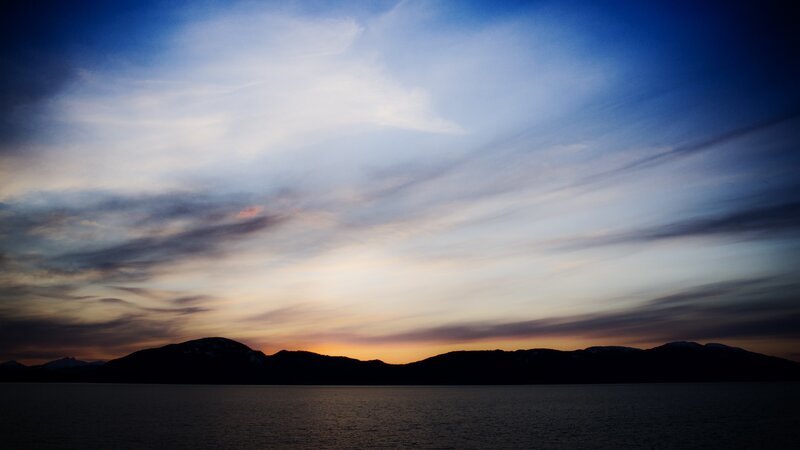 sunset over mountains and water