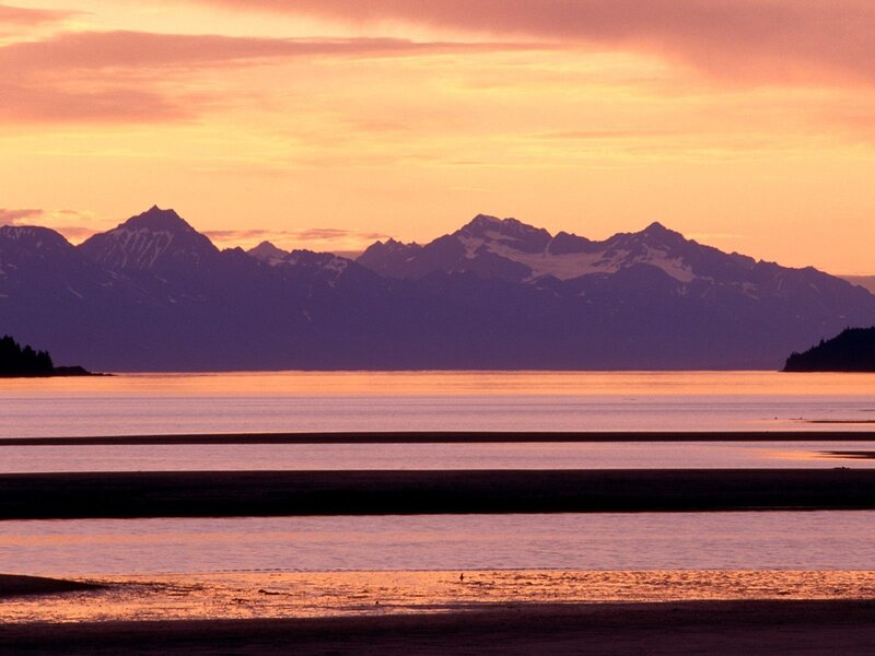 Sunset over mountains and water