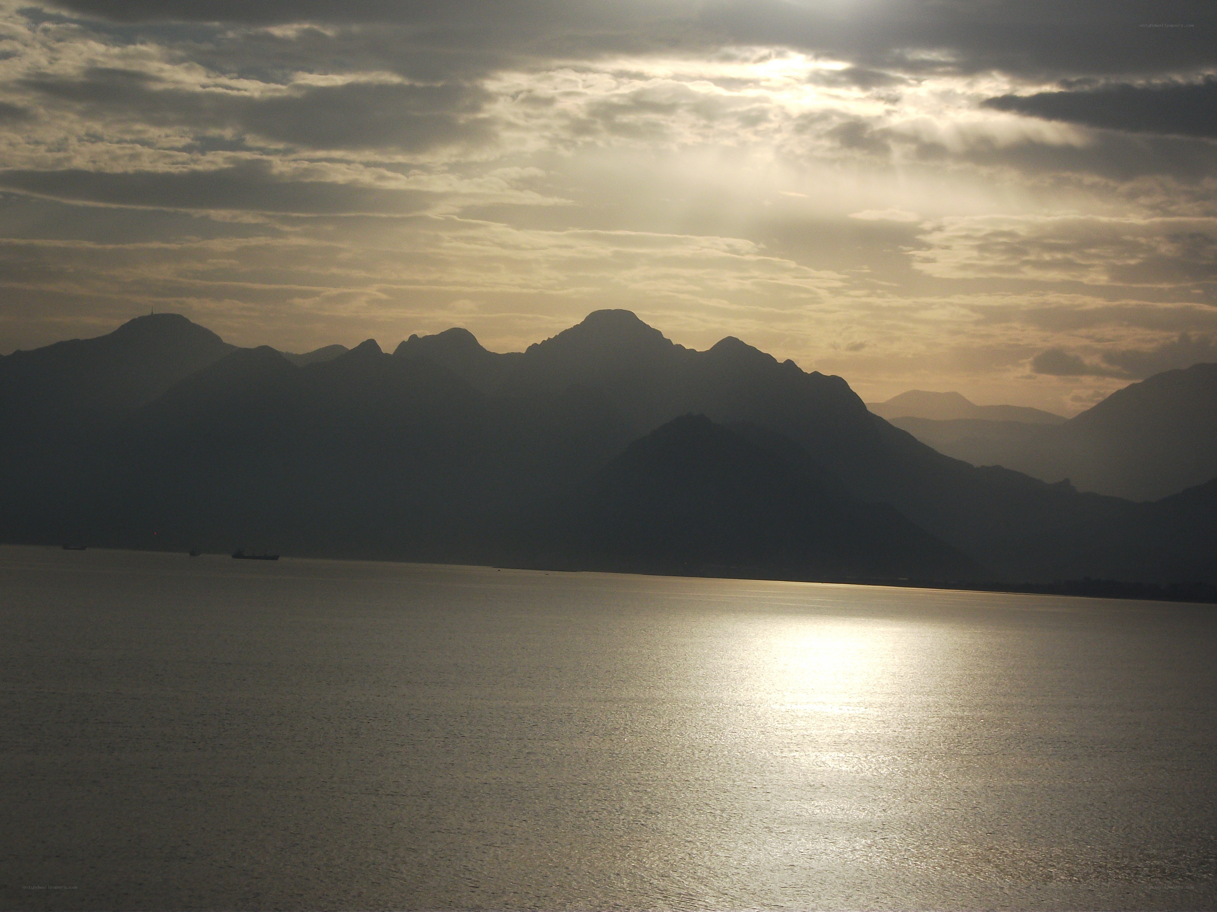 Sunset over mountains and water