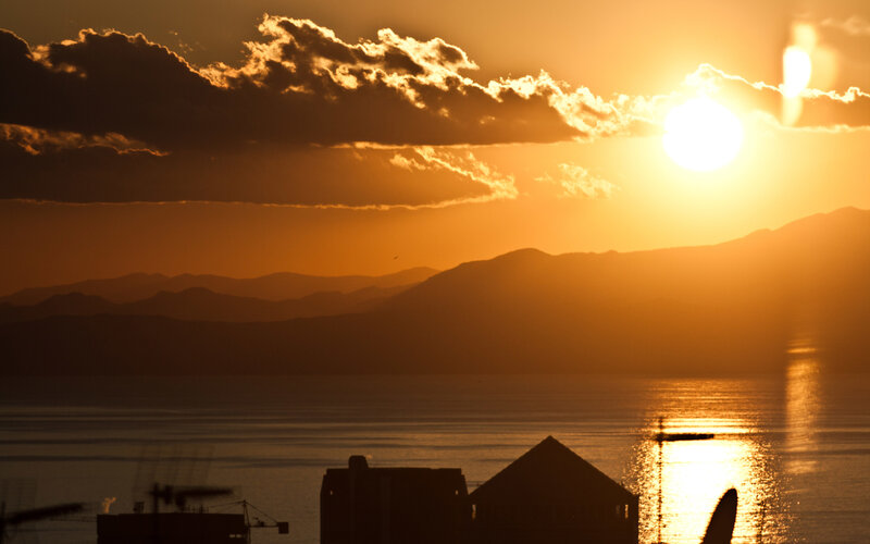 Sunset over mountains and water