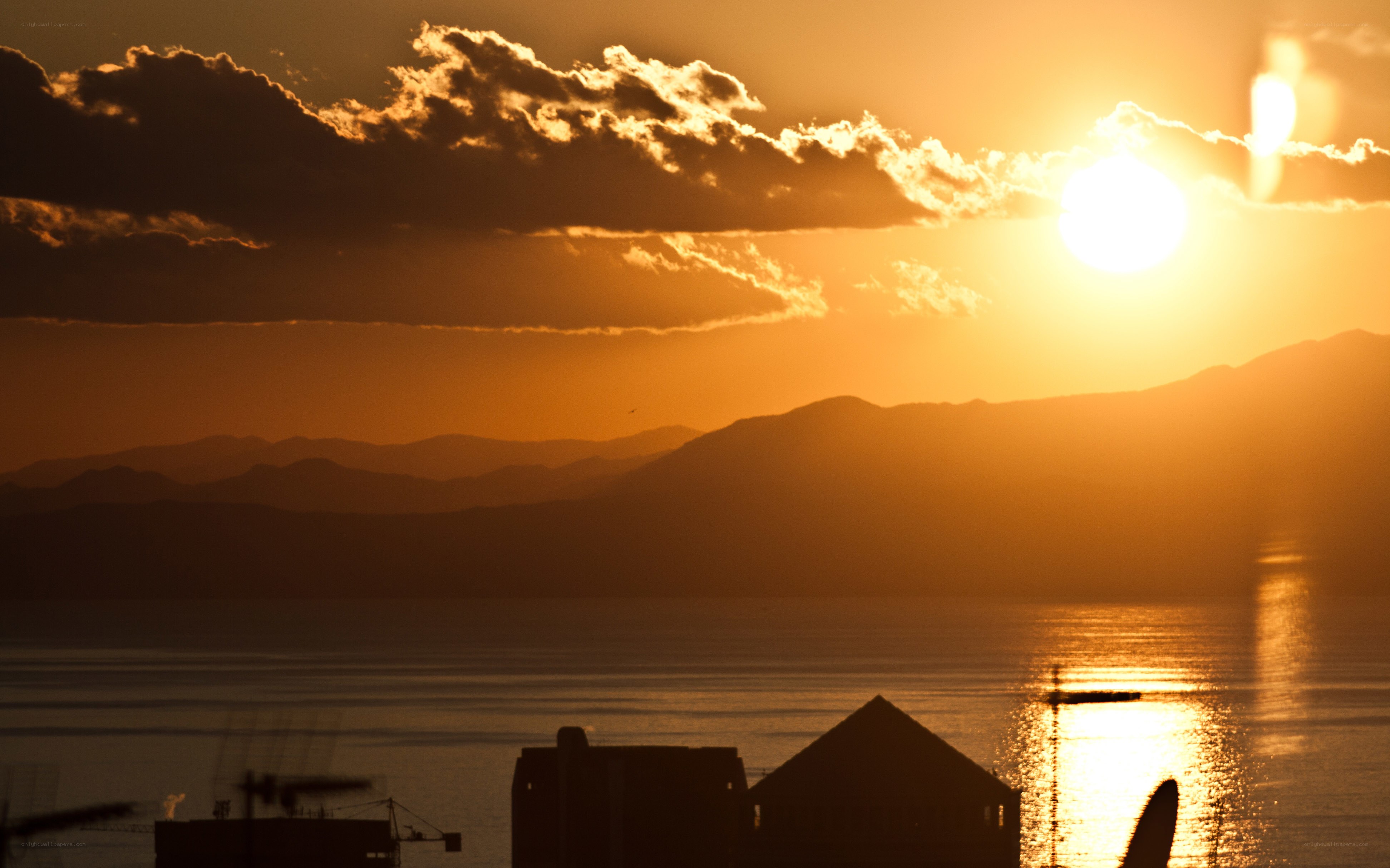 Sunset over mountains and water