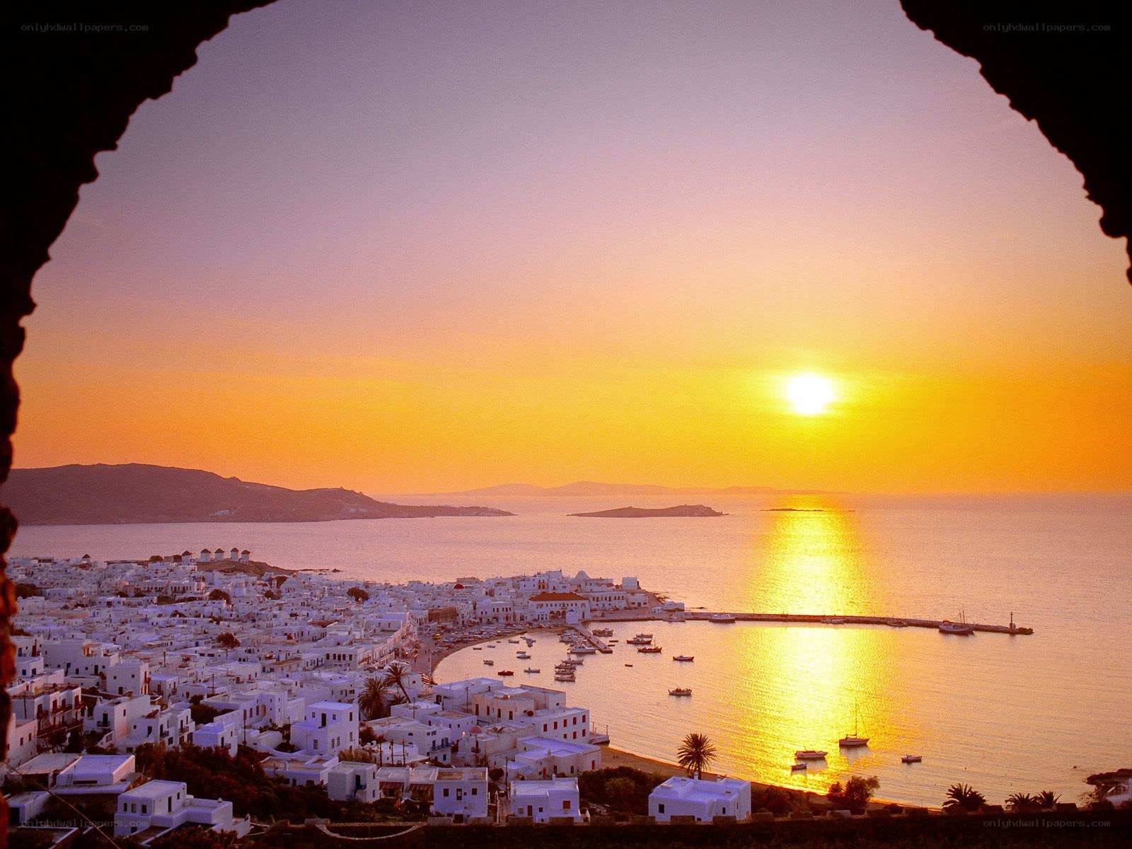 Sunset over Mykonos harbor