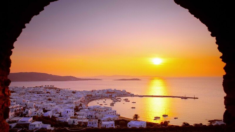 sunset over mykonos harbor