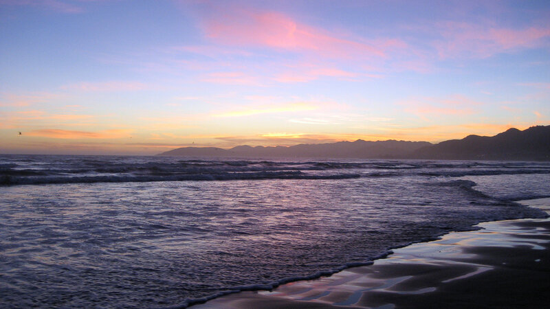 sunset over ocean and mountains