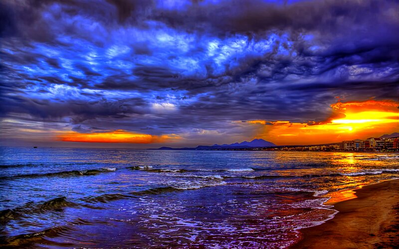 Sunset over Ocean Beach — Blue, Dramatic, Photograph, Clouds, Mountains