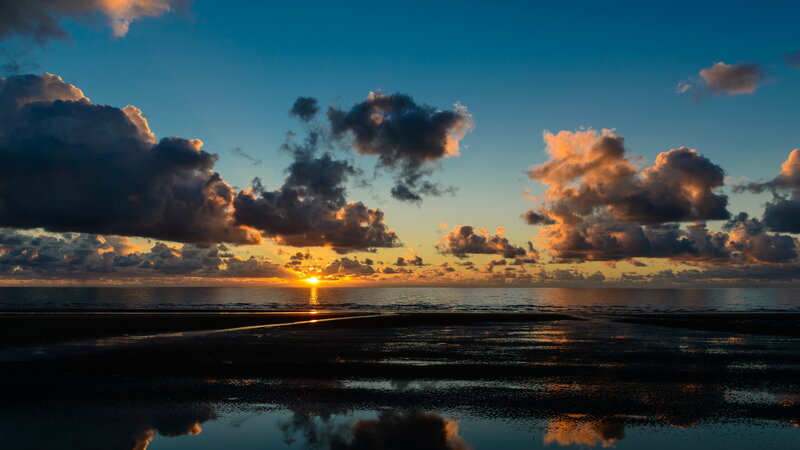 Sunset over Ocean Beach — Blue, Dramatic, Photograph, Clouds, Sun, Sand