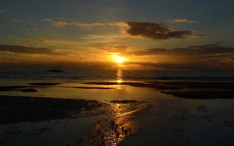 Sunset over Ocean Beach — Orange, Serene, Photograph, Boat