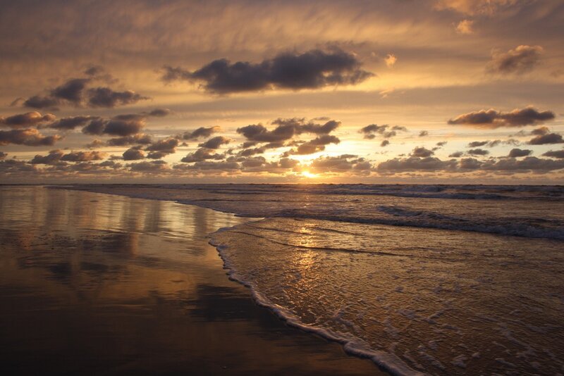 Sunset over Ocean Beach — Orange, Serene, Photograph, Clouds
