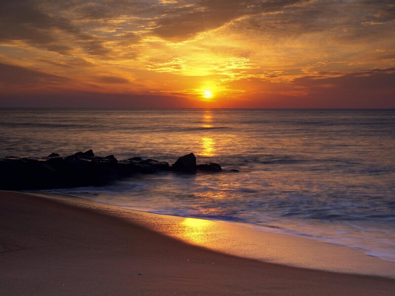 Sunset over Ocean Beach — Orange, Serene, Photograph, Rocks, Sand, Sky