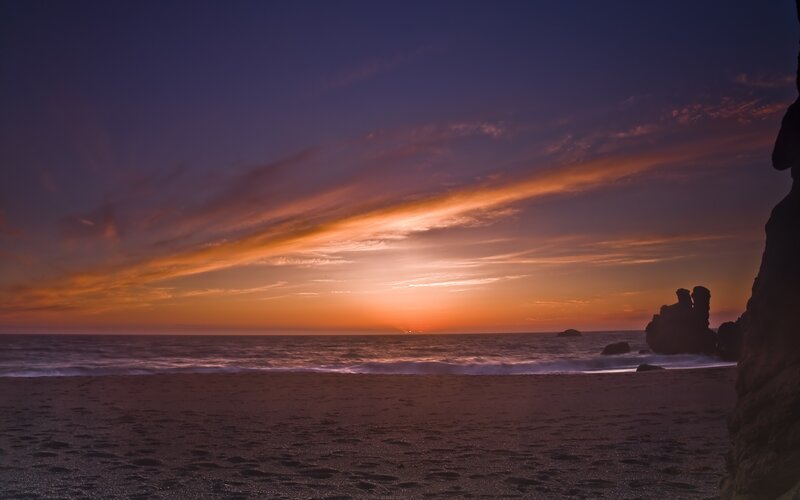 Sunset over Ocean Beach — Orange, Serene, Photograph, Sand, Rocks, Purple
