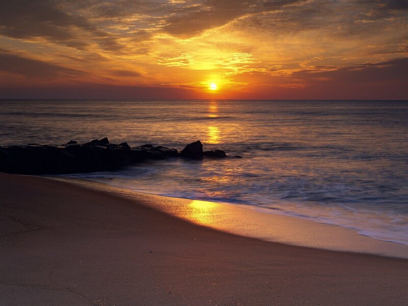 Sunset over Ocean Beach — Orange, Serene, Photograph, Sun, Sand, Rocks